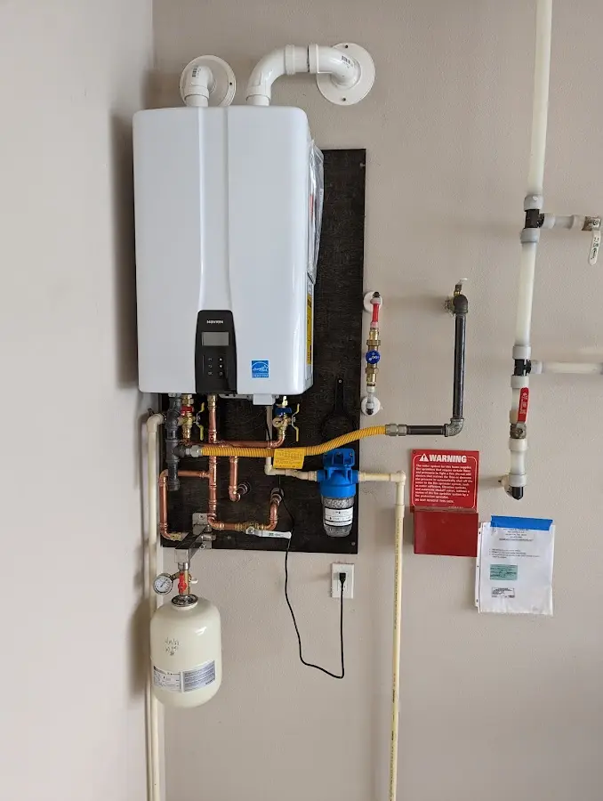 Professional plumber installing copper piping in a Haughton home